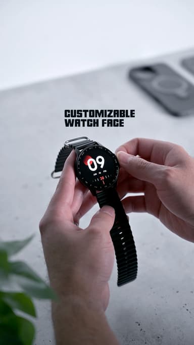 Two hands adjusting the ZIZO Tyme Elite 2, its screen showing a digital face