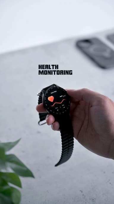 The ZIZO Tyme Elite 2 held in a hand, its screen showing a heart-rate reading