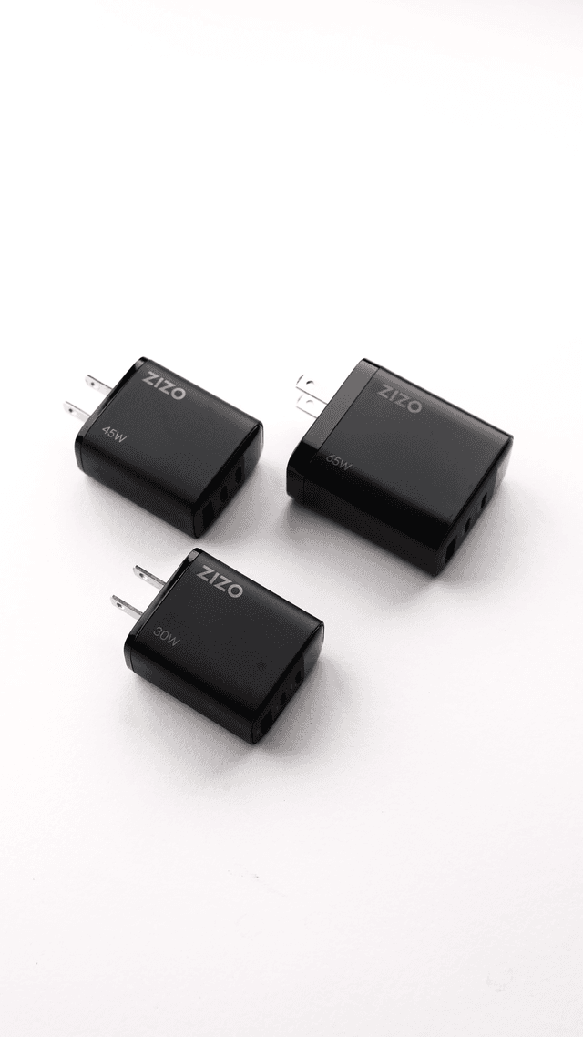 Three black ZIZO PowerVault wall chargers in 45W, 65W and 30W arranged on a white studio background
