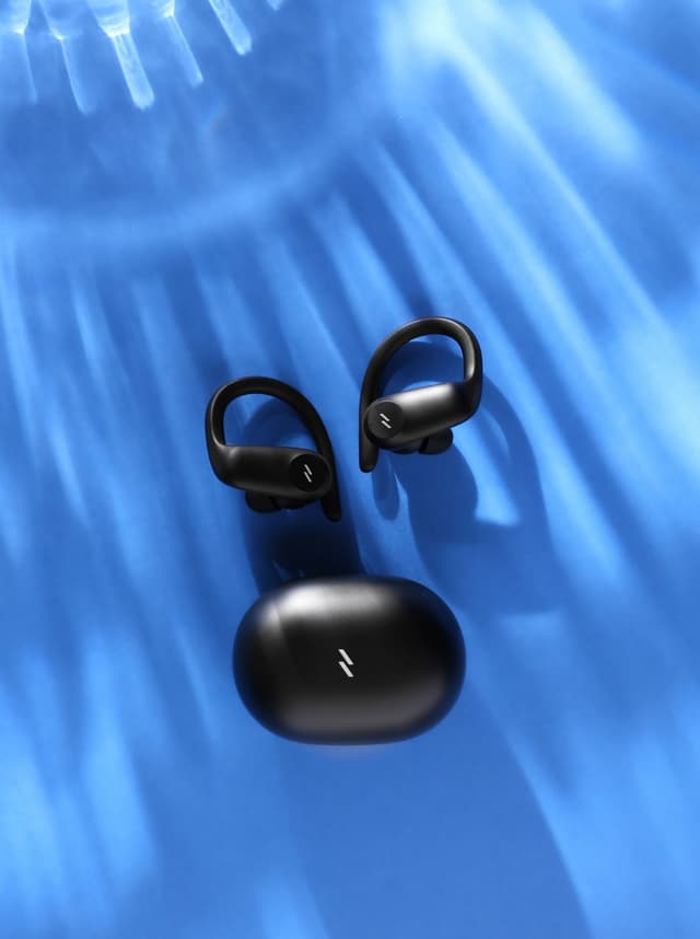 ZIZO Encore Sport Active Wireless Earbuds in Black with their charging case on a rippled blue surface