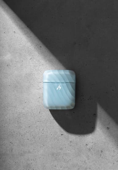 A pale blue translucent ZIZO Halos case closed, on gray concrete